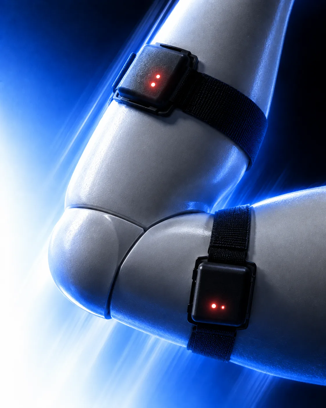 Product render of two strapped motion sensors on the joints of a robotic arm.